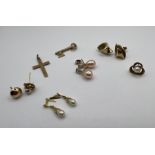 A pair of 9ct gold organic fold ear studs, along with a 9ct gold cross, a 9ct gold "18" key plus two