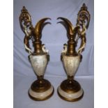 A pair of late 19th century gilt and cream finished spelter Renaissance style ewers, cast with