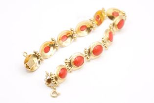 A yellow metal bracelet bezel set with cabochons of coral, with a granulated design, with functional