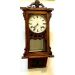 A Victorian oak and marquetry inlaid wall clock, foliage carved pediment, 8.5inch painted dial,