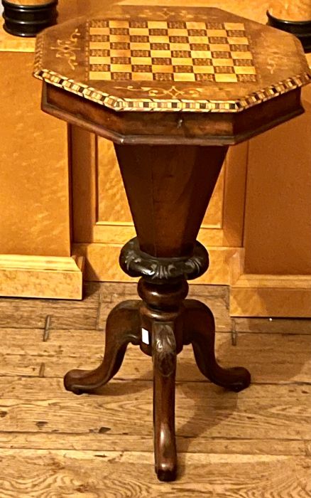 A Victorian walnut and marquetry games table, circa 1850, octagonal top with a lid encloses interior