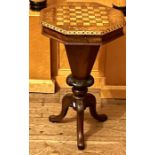 A Victorian walnut and marquetry games table, circa 1850, octagonal top with a lid encloses interior