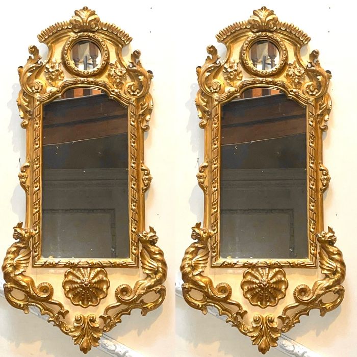 A pair of 19th century gilt gesso mirrors, scrolling foliage carving throughout on the frame, fitted