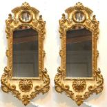 A pair of 19th century gilt gesso mirrors, scrolling foliage carving throughout on the frame, fitted