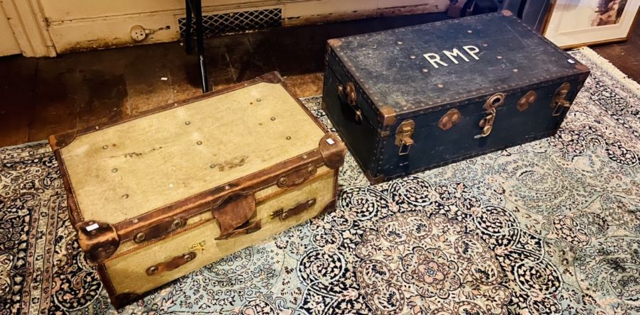 A pair of travel trunks: An early 20th century leather mounted travel trunk with brass lever