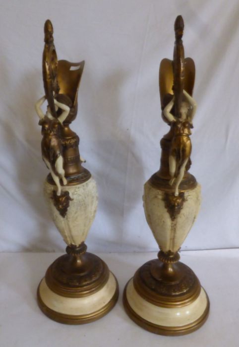 A pair of late 19th century gilt and cream finished spelter Renaissance style ewers, cast with - Image 4 of 4