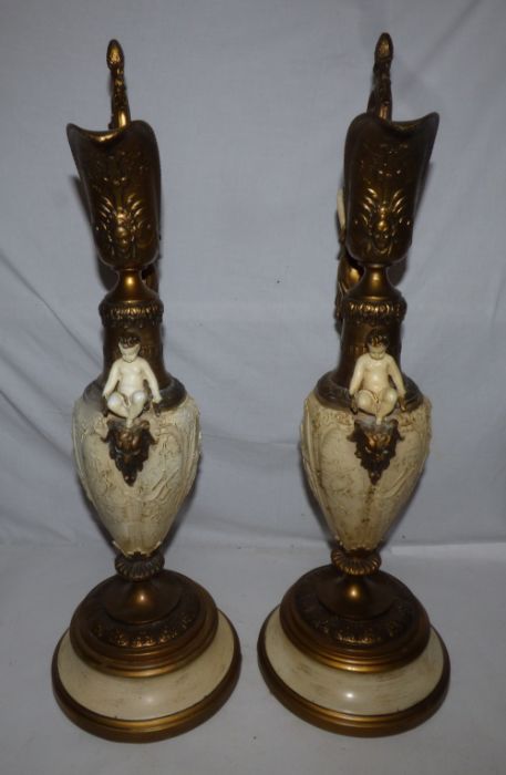 A pair of late 19th century gilt and cream finished spelter Renaissance style ewers, cast with - Image 2 of 4