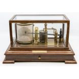 A cased barograph/weather station together with charts, thermometer and ink. In a mahogany case with