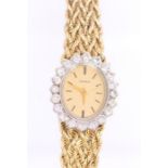 A ladies Genève diamond 14ct gold wristwatch, comprising an oval gold tone dial with applied gilt