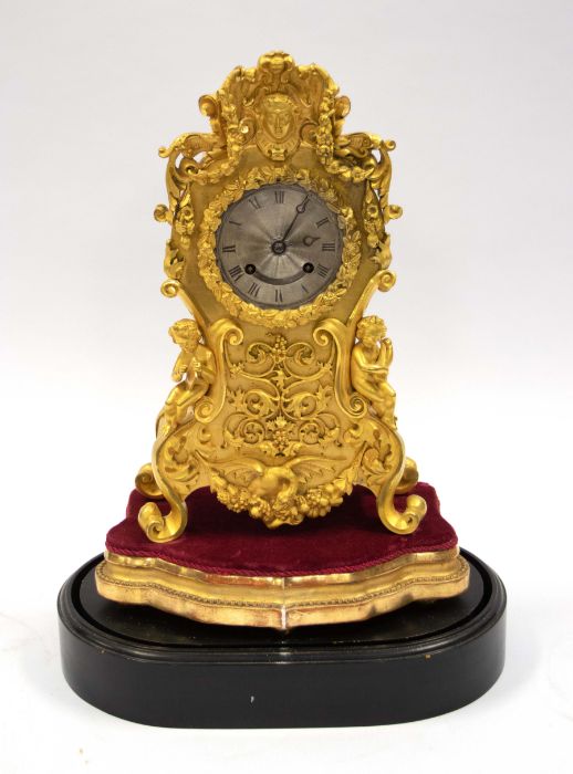 A Yveries of Paris French mantle clock or table clock under a glass dome, with 3" silvered dial, two