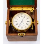 A small ship's deck chronometer/watch with 6cm silvered dial with Roman numerals, Arabic minutes and