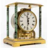 A Jaeger-LeCoultre Atmos clock with 4" white dial, contained in a brass case with four green
