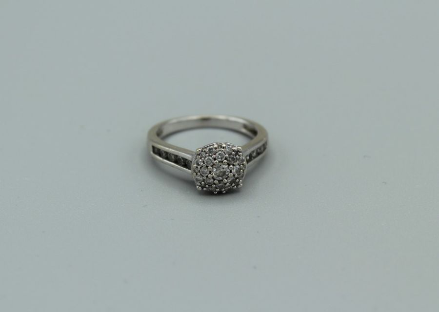 An 18ct white gold diamond cluster ring with total diamond weight of approx 0.45ct, 3.8gm approx