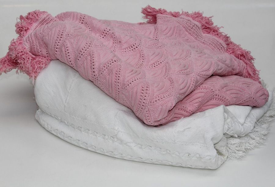 A woven pink cotton bedspread with tassle fringe, approximately 240 x 200cm together with a