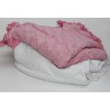 A woven pink cotton bedspread with tassle fringe, approximately 240 x 200cm together with a