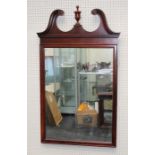A 20th century mahogany wall mirror, the urn and broken swan neck pediment over a moulded