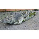 A nicely weathered reconstituted stone model of an alligator, 84cm
