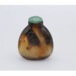 Snuff Bottle. Chalcedony of flattened pear shape resting on a small concave oval base, the darker