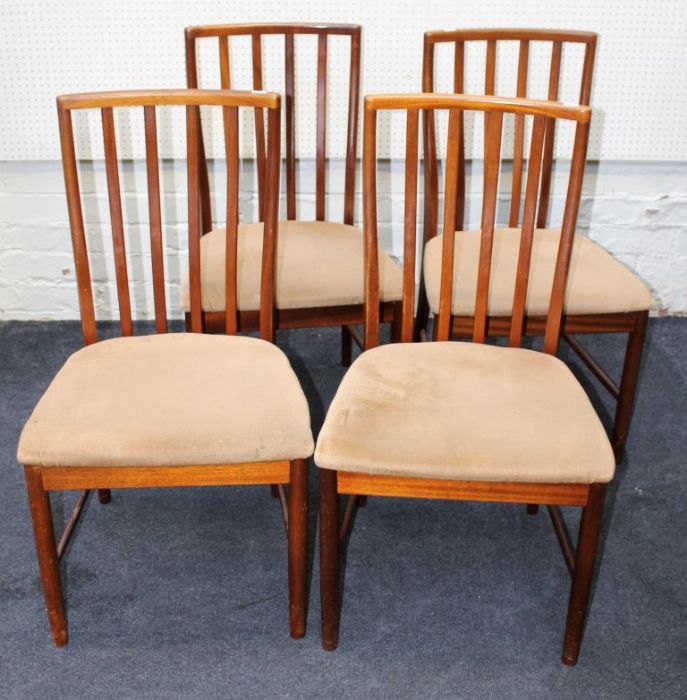 A set of six 1970's teak lathe back dining chairs, each with overstuffed seat, on turned forelegs (