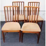 A set of six 1970's teak lathe back dining chairs, each with overstuffed seat, on turned forelegs (