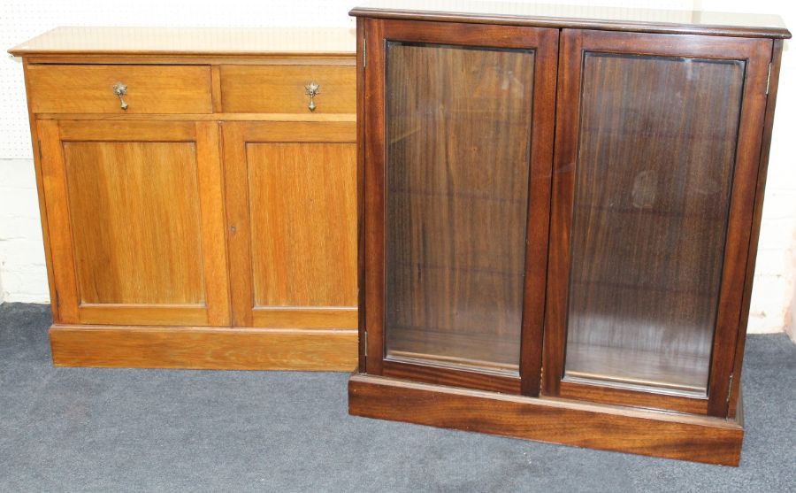 An Edwardian light oak cupboard, the rectangular top over two frieze drawers with brass drop handles