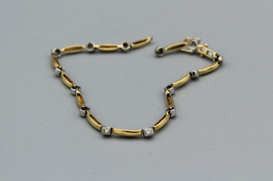 An 18ct gold and diamond bracelet with a broken link, gross weight approximately 7.9gm