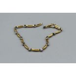 An 18ct gold and diamond bracelet with a broken link, gross weight approximately 7.9gm