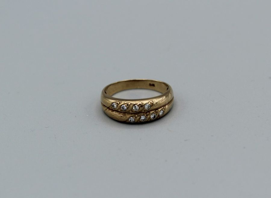 A diamond set double band ring in yellow metal stamped 375, gross weight approximately 2.2gm, size