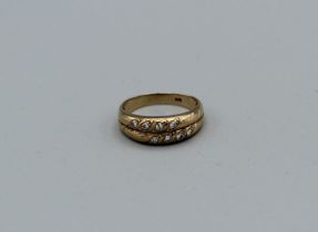 A diamond set double band ring in yellow metal stamped 375, gross weight approximately 2.2gm, size