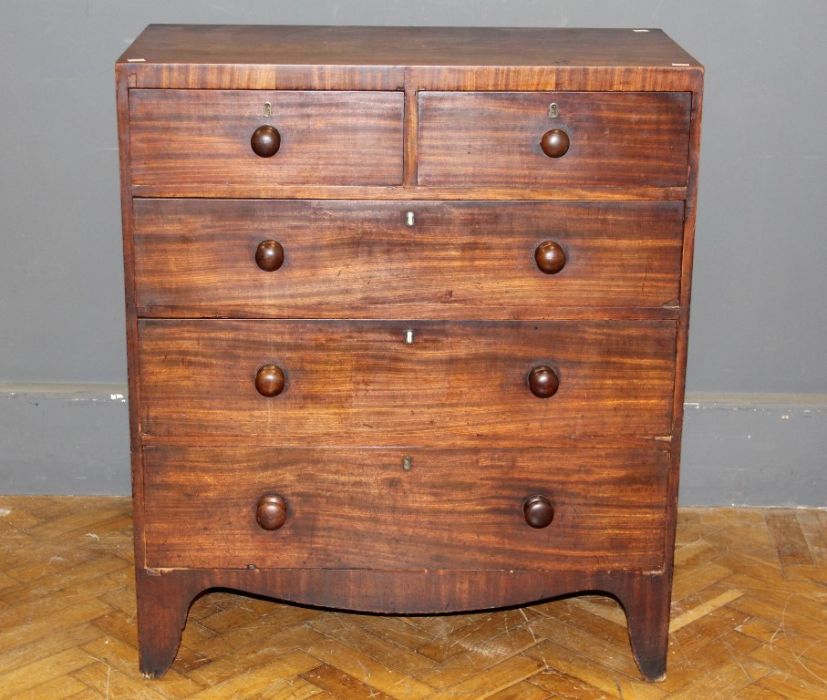 An early 19th century mahogany chest, the rectangular top over two short and three graduated long