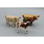 A Beswick figure of a Charolais calf, H7.5cm, another of a Highland calf, H7.5cm and a figure of