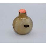 Snuff bottle. Chalcedony of bulbous form resting on a small oval base, lightly carved with cats