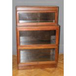 An oak Globe Wernicke type low bookcase of staggered outline W87cm