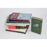 A small library of books, volumes include North America arts and design, Ornithology, museum guides,