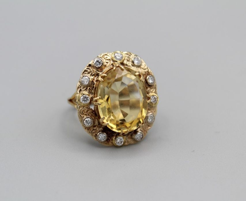 A Victorian citrine and diamond cocktail ring in ornate setting, gross weight approximately 7 gms,