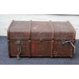 An Edwardian canvas, metal bound and wooded banded cabin trunk with twin leather handles and