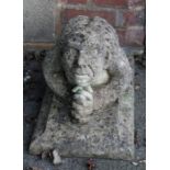 A reconstituted stone model of a kneeling goblin type creature, on rectangular plinth, 39 x 55 x