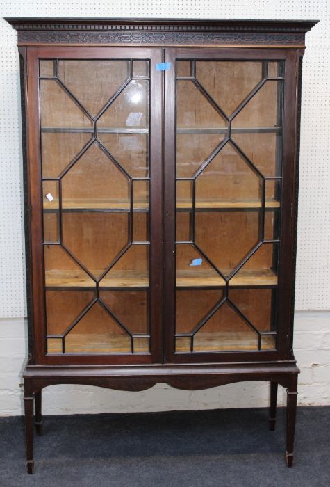 An Edwardian mahogany vitrine, the moulded and dentil cornice over blind fret carved frieze and a