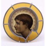 An aesthetic period leaded , stained and painted circular glass panel, centrally decorated with