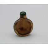 Snuff Bottle. Chalcedony of compressed round form resting on a small flat base, the stone suffused