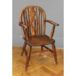 A 19th century beech and elm wheel and stick back Windsor armchair, with saddle seat on ring