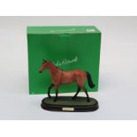 A Beswick style figure of Red Rum raised on a plinth with box, h23cm