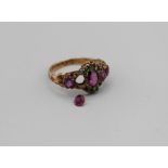 A garnet and green stone 15ct gold hallmarked- as found- one stone inset. Shank has a detailed