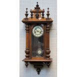 A late 19th century walnut cased Vienna wall clock, the twin train gong striking movement faced by