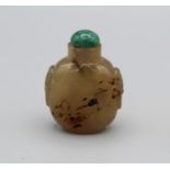 Snuff Bottle. Chalcedony of bulbous ovoid form, with a raised footrim and tao tie mask handles at