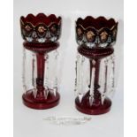 A pair of Edwardian ruby glass, florally enamel decorated table lustres, each with icicle pendant