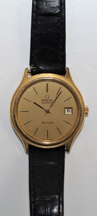 A gentleman's Omega De Ville Quartz with gold dial, baton numerals, with date window. On a leather