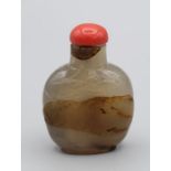 Snuff bottle. Chalcedony of rounded rectangular form on a raised footrim, carved in low relief