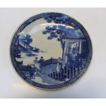 An early 20th century Japanese blue and white charger, decorated with figures and pagodas beneath