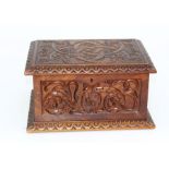 An oak wood cutlery box featuring poker work decoration, engraved Celtic style sea monsters and
